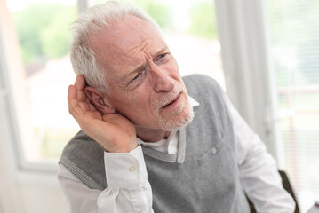 Senior man with hearing problems