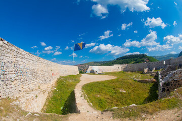 Flag of Bosnia and Herzegovina rise waving to the wind with sky in the background
