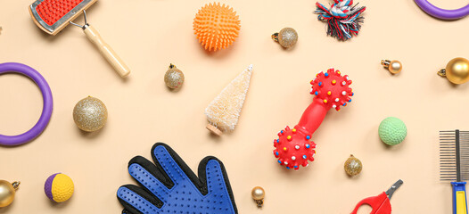 Fototapeta na wymiar Pet accessories with Christmas balls on beige background