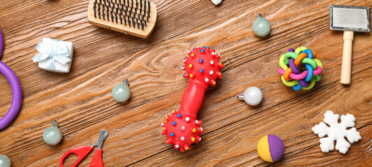 Pet accessories with Christmas decor on wooden background