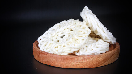 Krupuk Uyel or Kerupuk Uyel is one of type Indonesia traditional crackers. Served in wooden plate....