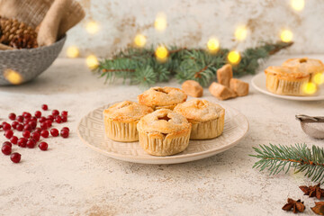 Plate with tasty mince pies on grunge background