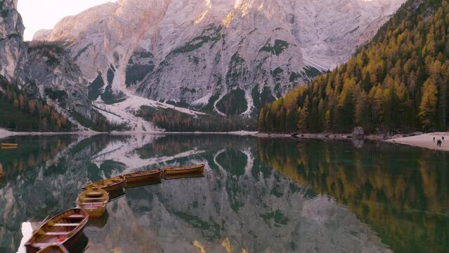Row Boats on Italy's Famous Lake Braies, Italian Dolomites. Colorful Trees Autumn Day. Mountain Reflection in Water