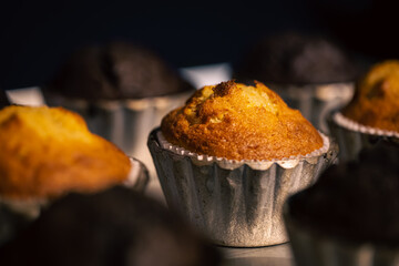 Freshly baked muffins in metal molds close-ups in a bakery.