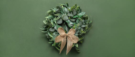 Beautiful Christmas wreath on green background