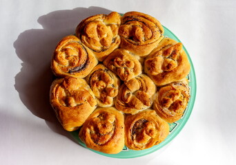 Buns with poppy seeds close-up on a white background