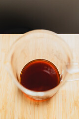 server with brewed coffee over a wooden desk
