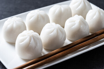 Steamed dumplings on black slate background