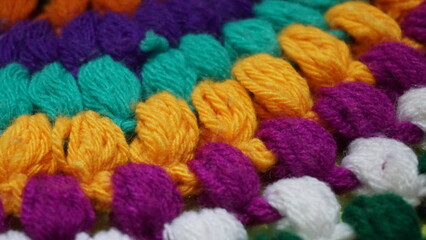 Piece of Colorful Knitted fabric, background or texture. Knitting yarn handmade.