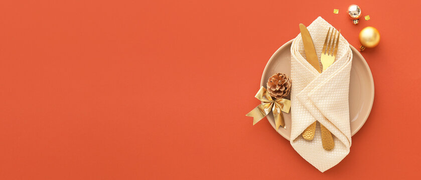 Beautiful Christmas table setting on orange background with space for text