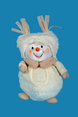 Toy christmas snowman isolated on a blue background. Handmade Christmas holiday decorations