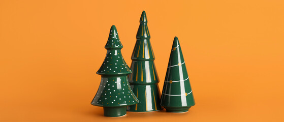 Ceramic Christmas trees on orange background