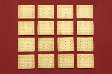 Salty cracker pattern on maroon red background