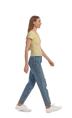 Young woman in casual outfit walking on white background