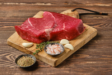 Fresh raw top side beef steak on wooden tabletop