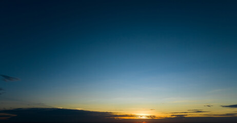 Fototapeta premium Dramatic golden and dark blue sunset sky abstract background. Dark blue sky in the evening. Sky at dusk. Sunset abstract background. Dusk and dawn concept. Beauty in nature.Majestic sky for wallpaper.