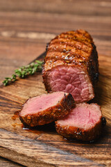 Closeup view of roasted beef brisket flat steak on wooden cutting board