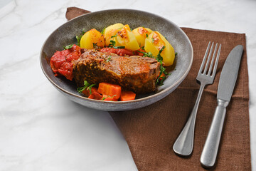 Slow cooking food. Beef meat braised in beer gravy