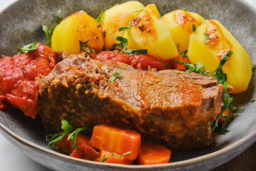 Closeup view of beef meat baked in beer gravy