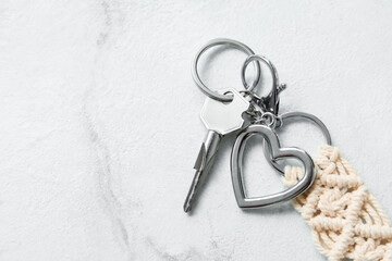 Key with keychains on light background