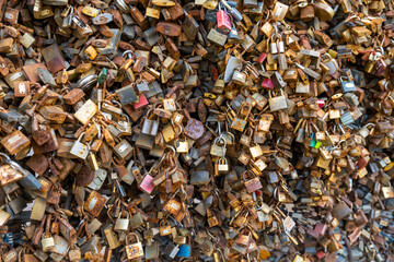 close-up view of thousands of rusted and colorful love locks full of secrets and promises