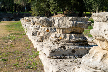 Fototapeta na wymiar close-up low angle view of old column bases in the Palestra in Ancient Olympia