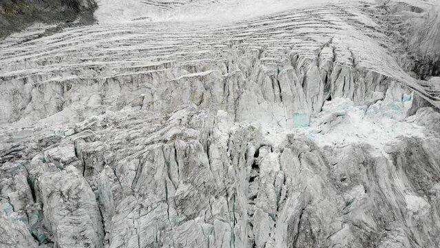 Aerial flyover over the Moiry glacier near Grimentz in Valais, Switzerland with a pan up from the icy crevasses
