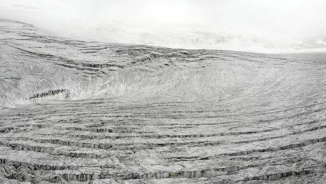 Aerial view of the crevasses of Moiry glacier near Grimentz in Valais, Switzerland on a cloudy day