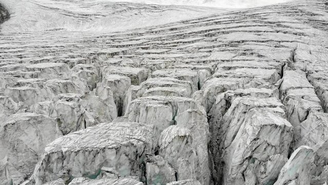 Aerial flyover over the Moiry glacier near Grimentz in Valais, Switzerland with a pan down view straight into a crevasse