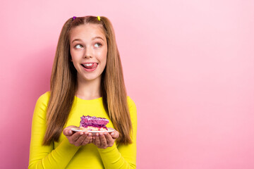 Photo of tricky cunning school girl dressed yellow top ready eating cake piece looking empty space isolated pink color background