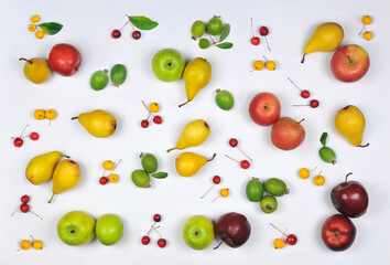 Vitamin healthy fruit set from  fresh  ripe apples , pears, paradise apples and fejhoa with green leaves on white background .Top view, flat lay.