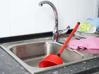 Release the blockage of sink with a rubber plunger