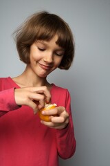 female child cheerful contented face, peel tangerine