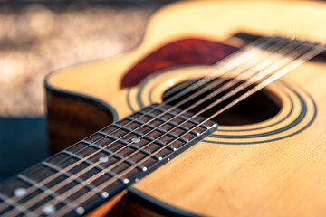 Fototapeta na wymiar Close-up, classical acoustic guitar, soft focus in daylight.