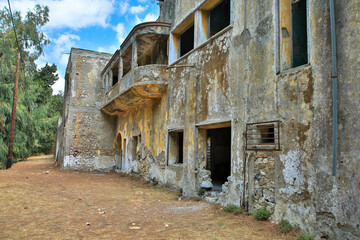 Fototapeta na wymiar Lost Place in Eleousa. Village on the Greek island of Rhodes. It was built from 1935 during the Italian occupation of Rhodes under the name of Campochiaro. Derelict sanatorium. Rhodes, Greece.