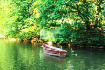 Naklejka na ściany i meble View of beautiful river with boat and green trees