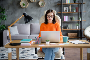 Photo of busy confident lady dressed orange pullover answers mails modern gadget indoors workshop...