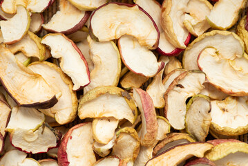 Close up of sliced dry apples, background, texture, top view. Autumn, preparing garden food for winter, harvesting