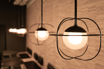 Fototapeta na wymiar Hanging Retro Lamps, Vintage Style Industrial Lightbulbs, Warm Light Bulb in Interior, Retro Lams