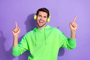 Photo of youngster student guy wear stylish new wireless headphones fingers up listen chill music...