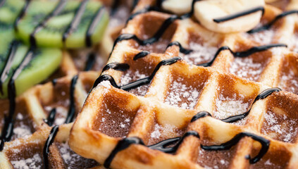 Close-up, Belgian waffles with fruits, covered with chocolate.