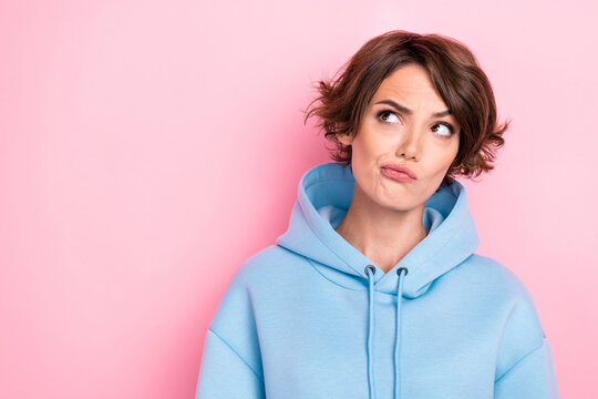 Photo of nice minded lady interested look empty space make decision choice wear blue stylish sportswear isolated on pink color background