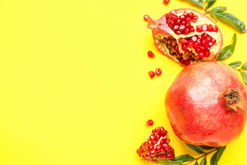 Fresh ripe pomegranates on yellow background