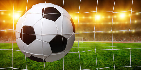 Soccer ball in goal on stadium