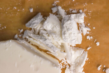 Soy wax. Broken pieces of soy wax on parchment close-up