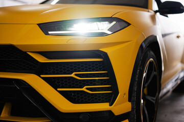 Obraz na płótnie Canvas Headlights of yellow sport car suv.