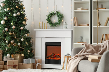 Interior of living room with Christmas wreath, fireplace and fir tree