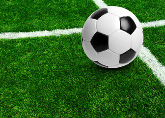 Soccer ball on stadium field texture