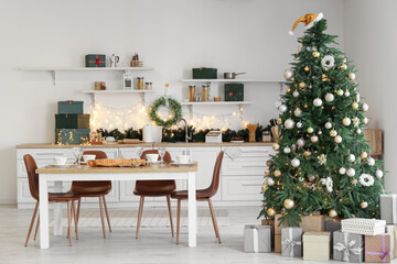 Interior of kitchen with Christmas tree and dining table