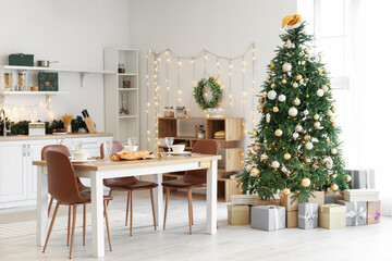Interior of kitchen with Christmas tree and dining table